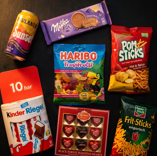 Kleines Deutschland mystery box open showing imported German snacks, Milka chocolate bars, Haribo gummies and drinks